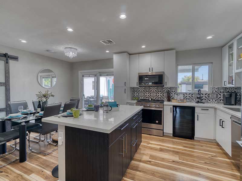 A modern kitchen featuring stainless steel appliances and elegant hardwood floors.